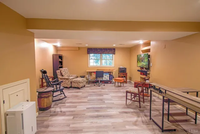 a kitchen with stainless steel appliances granite countertop a table chairs sink and cabinets