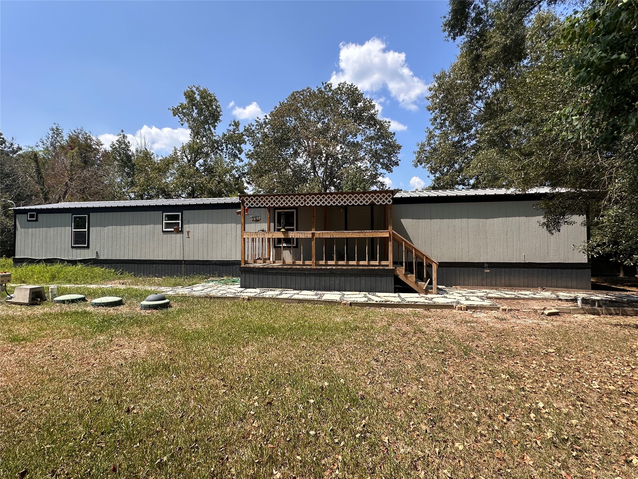a view of a house with pool and a yard