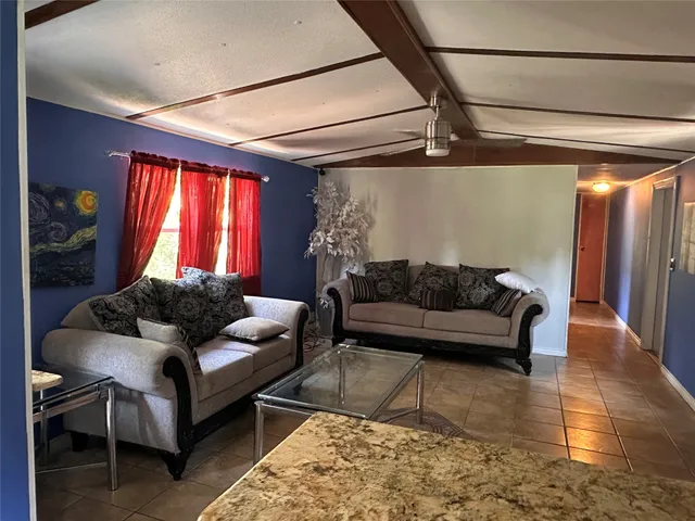 a living room with furniture and a window