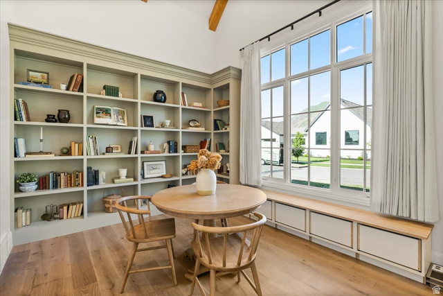 478 South Maple Lakes Drive Mapleton, UT 84664 - Photo 18 of 51 Spacious room featuring extensive built-in shelving, large multi-pane windows, wood-finish flooring, a vaulted ceiling with exposed beam, and integrated window seating with storage