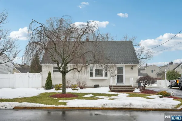 a view of a house with snow on the side of a road