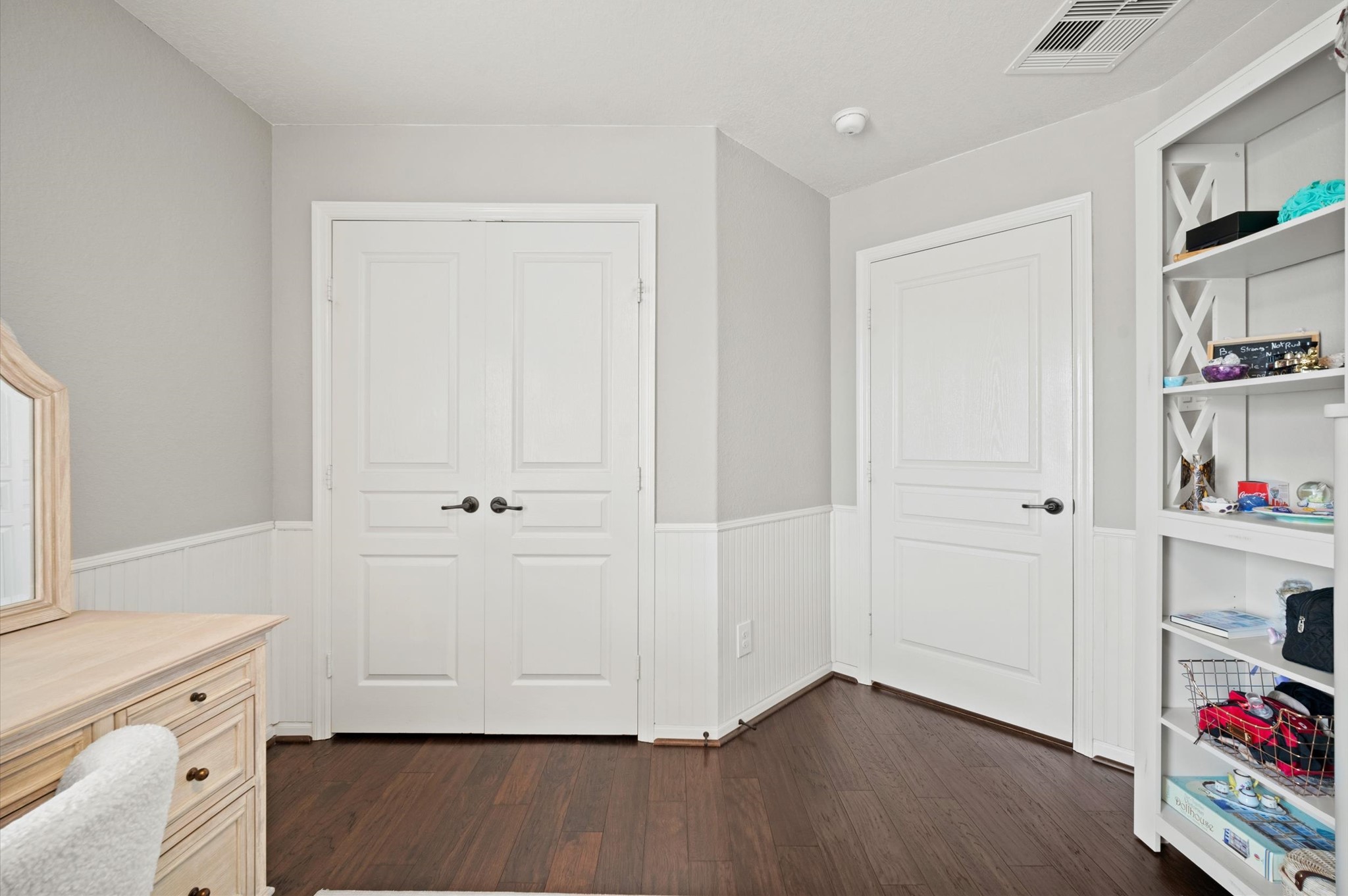9507 Empress Crossing Drive Spring, TX 77379 - Photo 37 of 50 This room features elegant dark wood flooring and neutral walls, offering ample storage with double doors and built-in shelving. Perfect for a home office or study space.