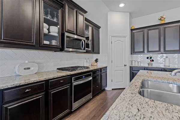 a kitchen with stainless steel appliances granite countertop a stove and a sink