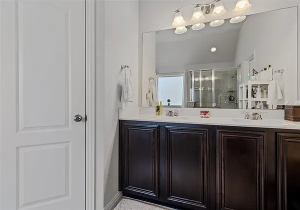 a bathroom with a double vanity sink and a mirror