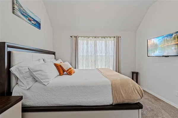 a bedroom with a bed and window