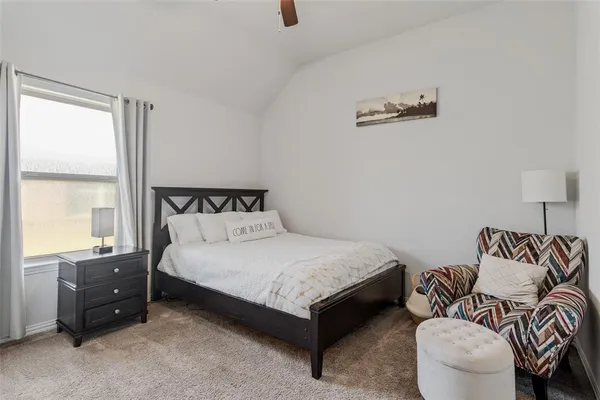 a bedroom with a bed and a couch