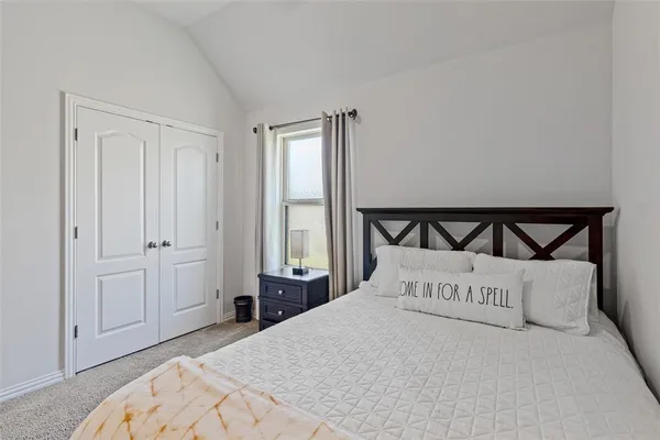a bedroom with a bed and window