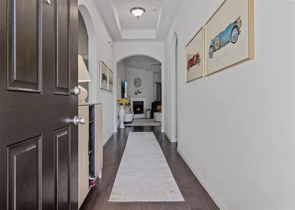 a view of a hallway with wooden floor and stairs