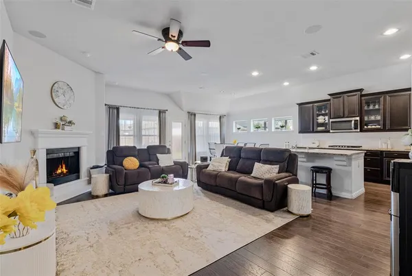 a living room with furniture fireplace and flat screen tv