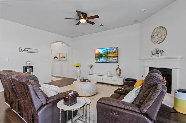 a living room with furniture a rug and a fireplace