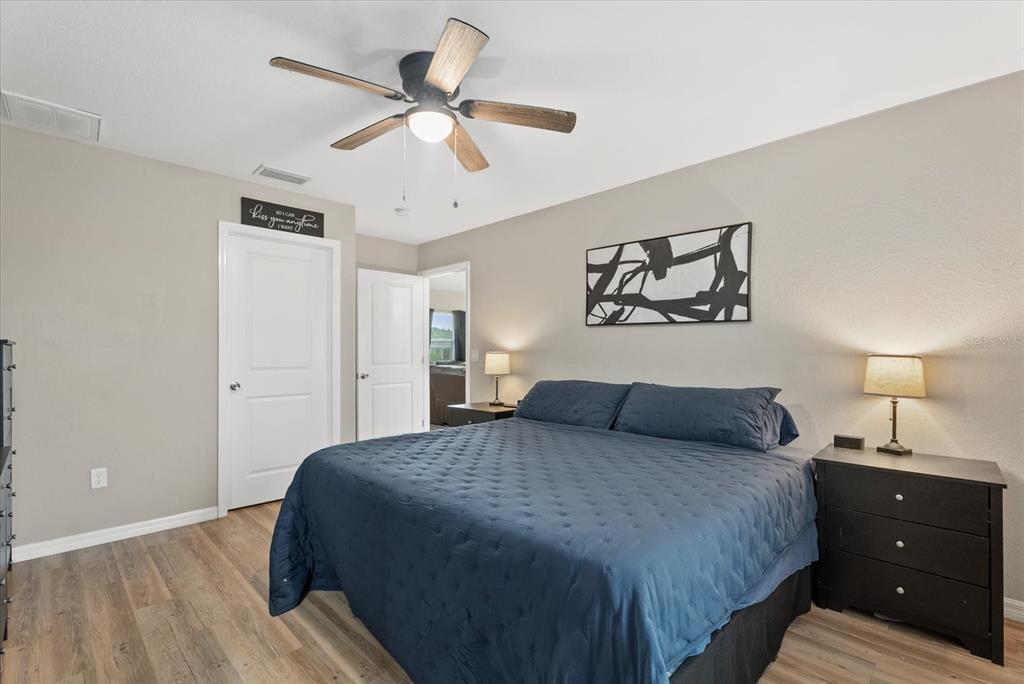 8288 Southwest Sunnybreeze Road Arcadia, FL 34269 - Photo 10 of 18 a bedroom with a large bed and a chandelier