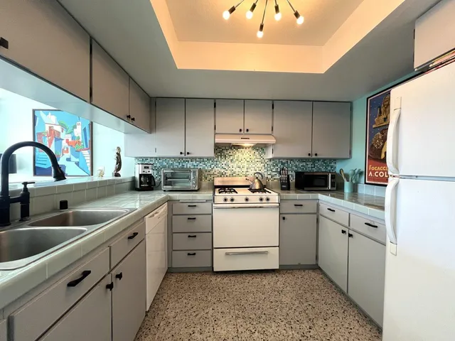 a kitchen with cabinets and steel stainless steel appliances