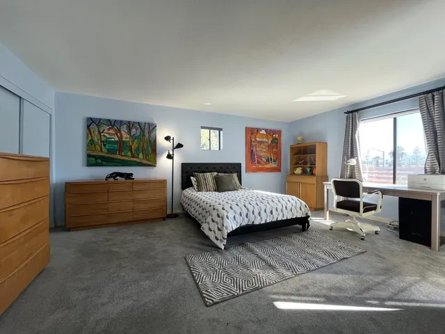 a bedroom with a large bed and a walk in closet