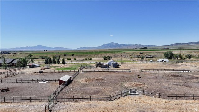 1634 West Arimo Road Arimo, ID 83214 - Photo 78 of 89 Expansive fenced paddocks with multiple outbuildings, including a red shed and several barns