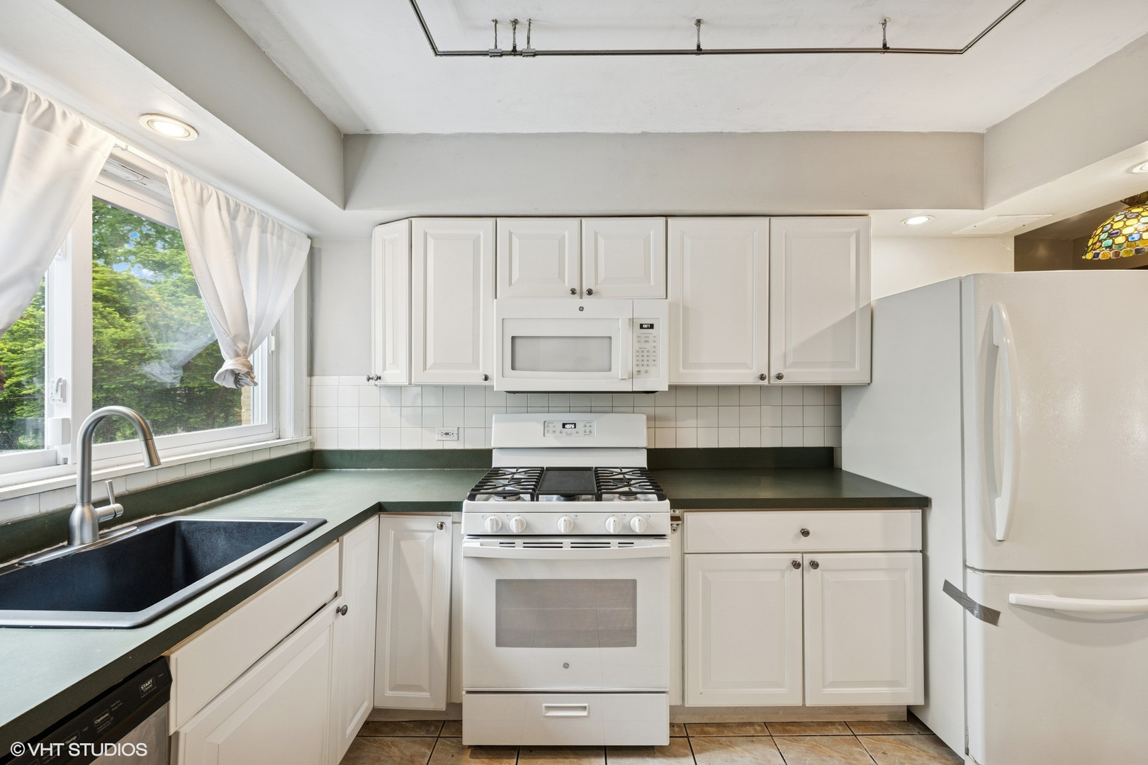 1800 Shermer Road Northbrook, IL 60062 - Photo 5 of 21 a kitchen with white cabinets and white appliances