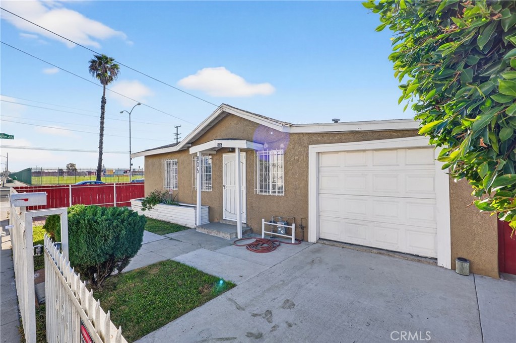 806 West Spruce Street Compton, CA 90220 - Photo 4 of 41 a view of a house with a yard and potted plants