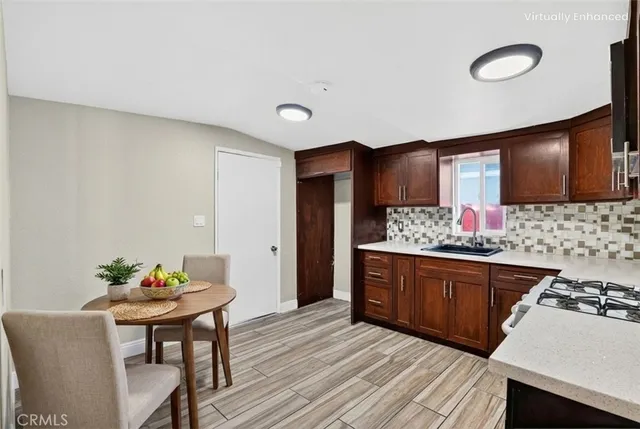 a kitchen with stainless steel appliances granite countertop a sink stove and cabinets