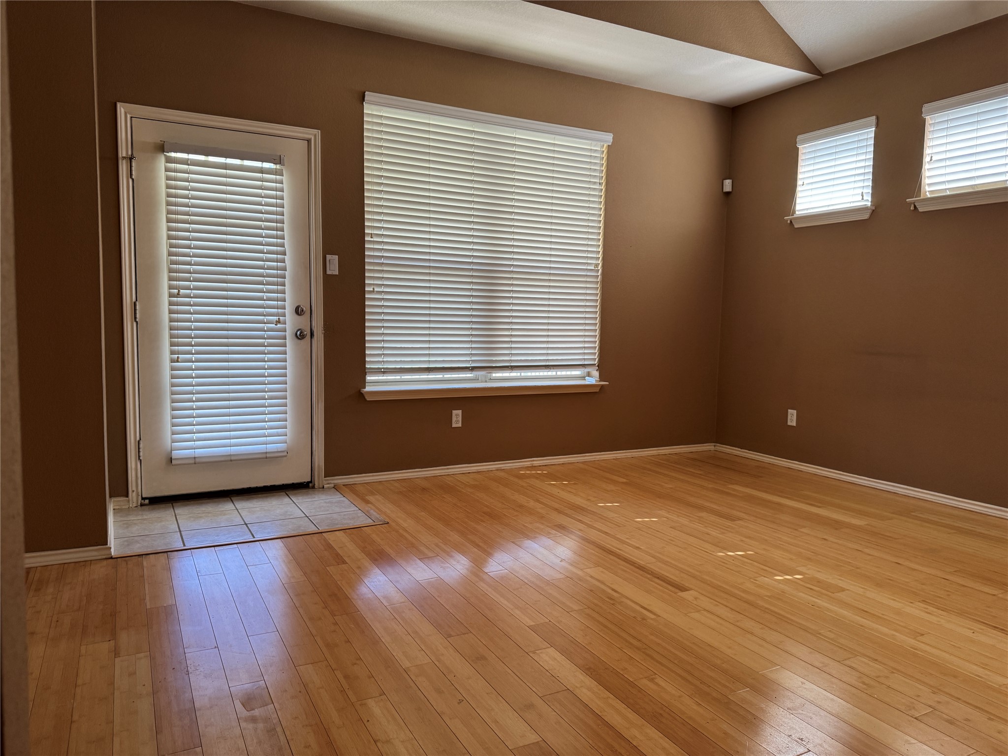 1900 Scofield Ridge Parkway, Unit 3503 Austin, TX 78727 - Photo 3 of 16 a view of an empty room with wooden floor and a window