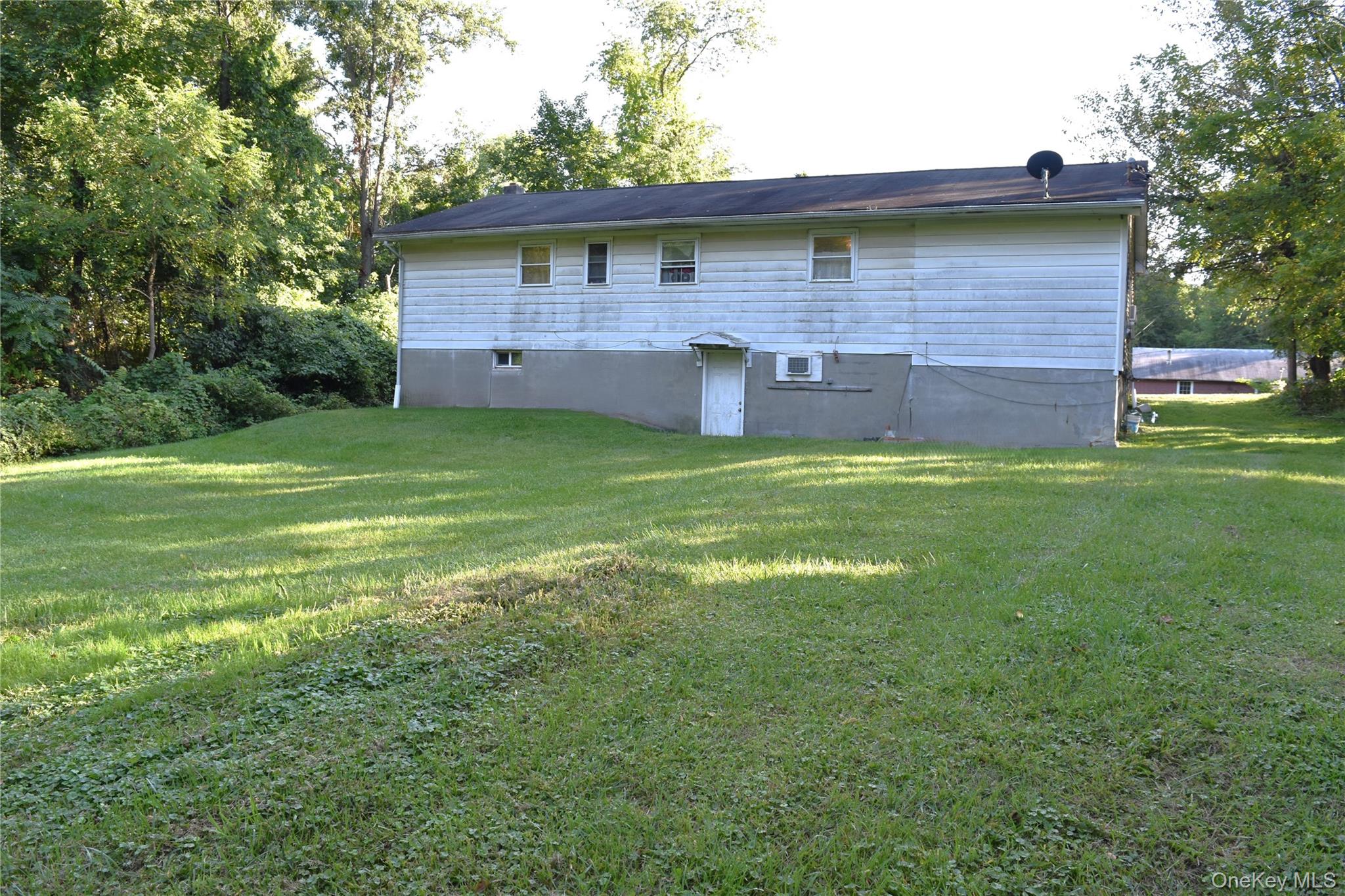 164 Brookside Farms Road Newburgh, NY 12550 - Photo 18 of 18 a view of a backyard with a garden