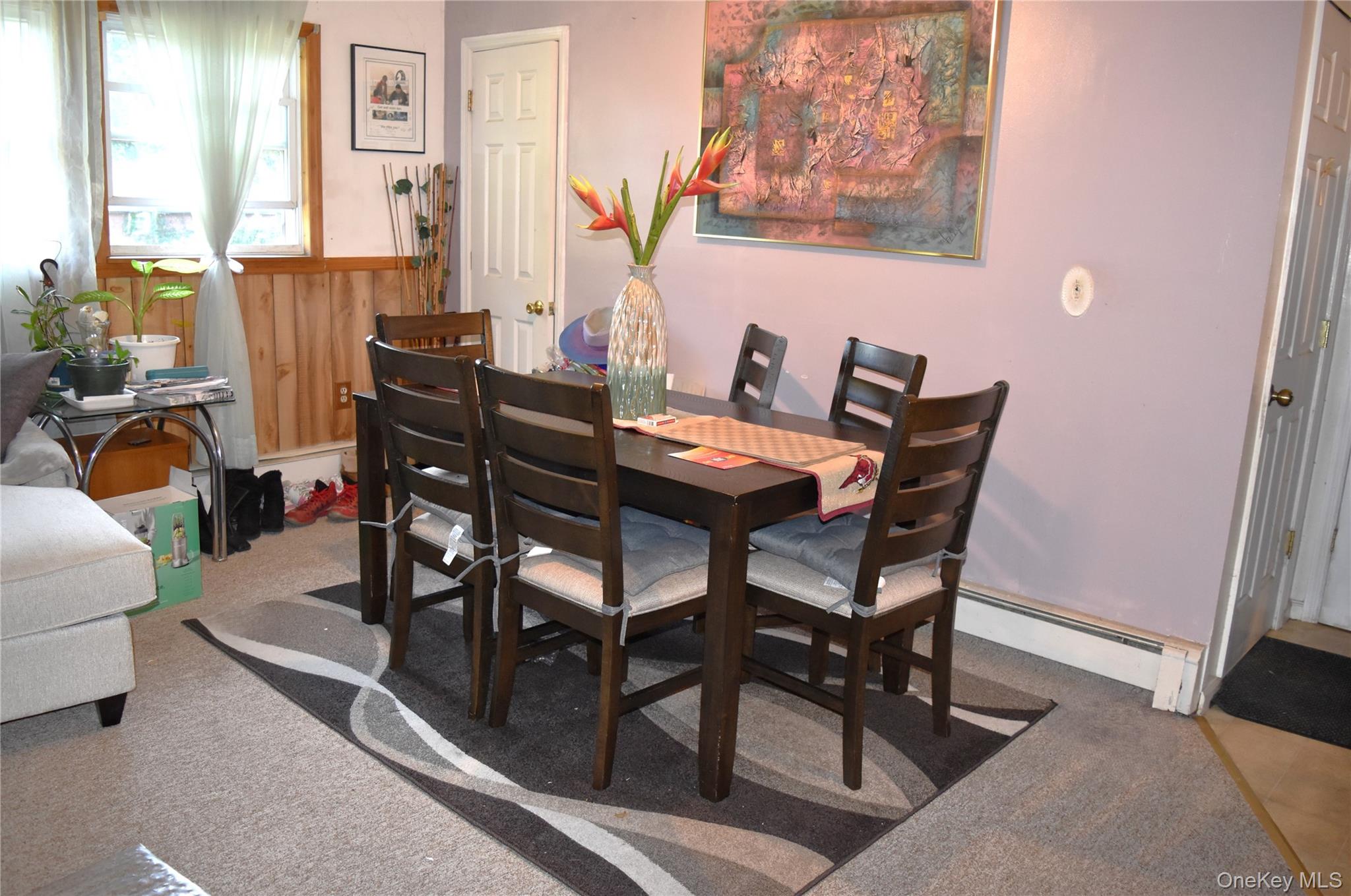 164 Brookside Farms Road Newburgh, NY 12550 - Photo 7 of 18 a view of a dining room with furniture and a potted plant