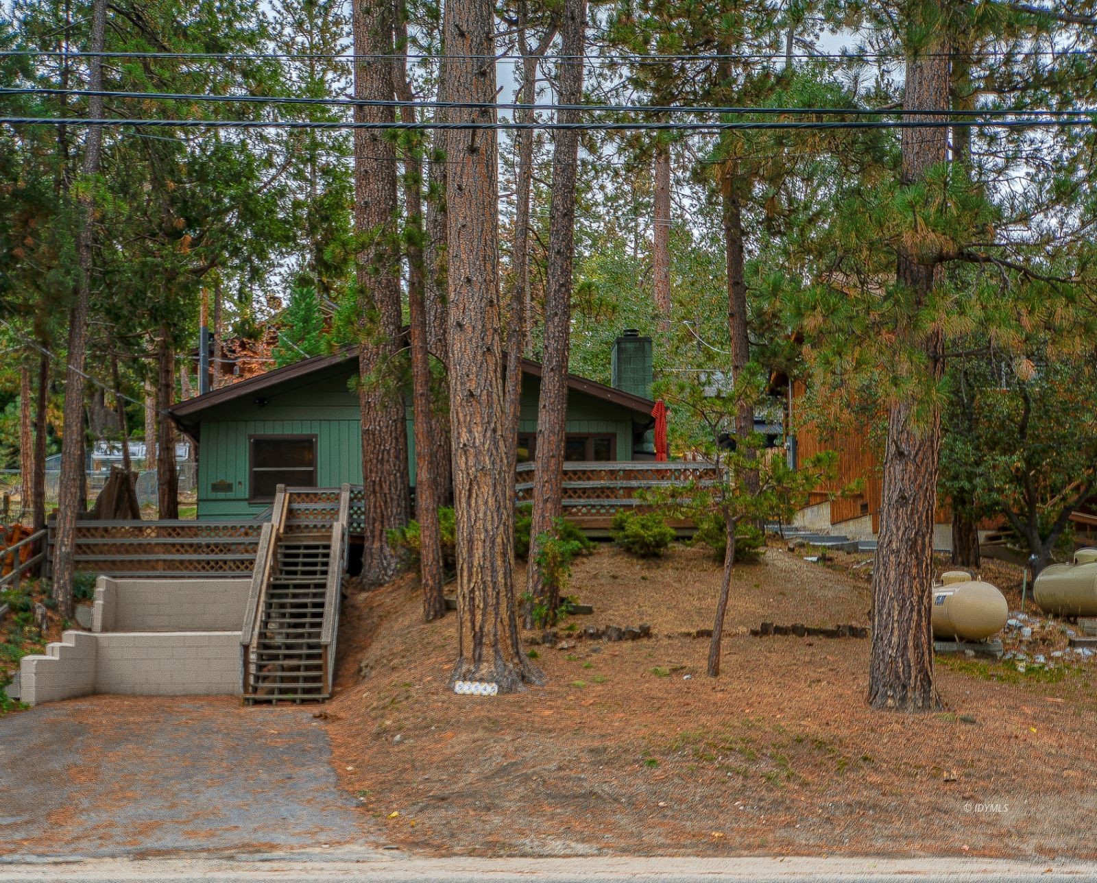 a view of backyard with a car parked in the background