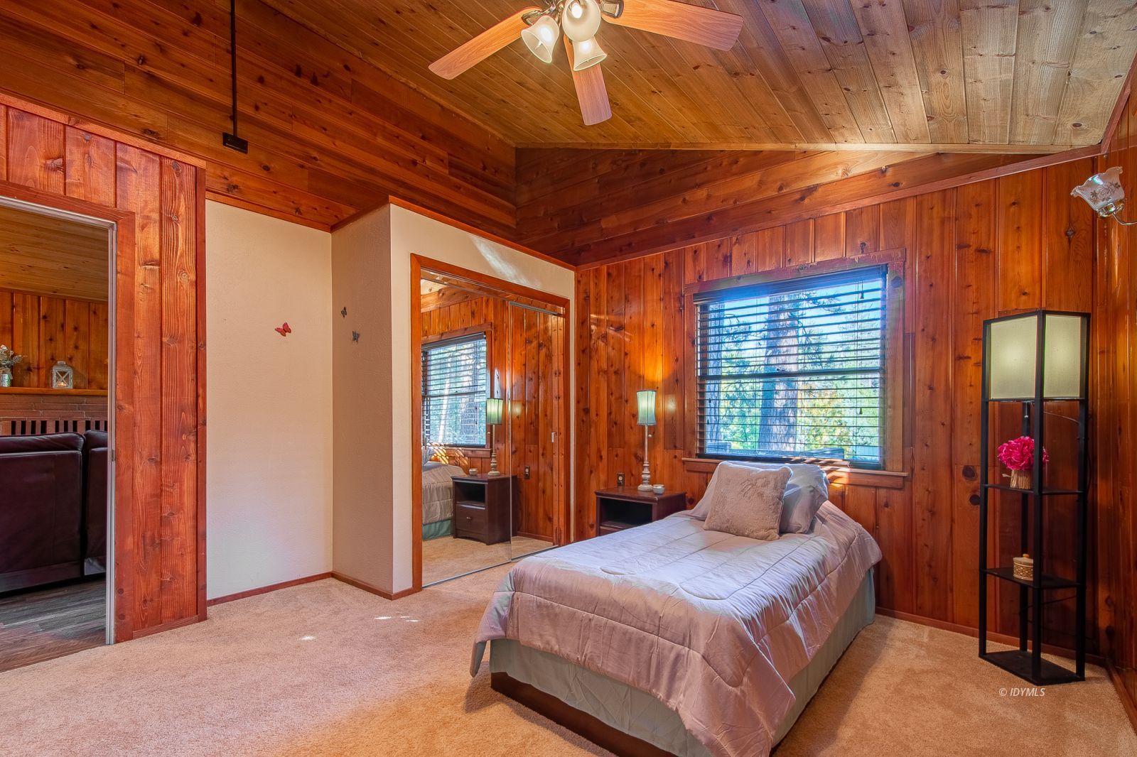 53545 Tollgate Road Idyllwild, CA 92549 - Photo 16 of 30 a bedroom with a bed and a chandelier
