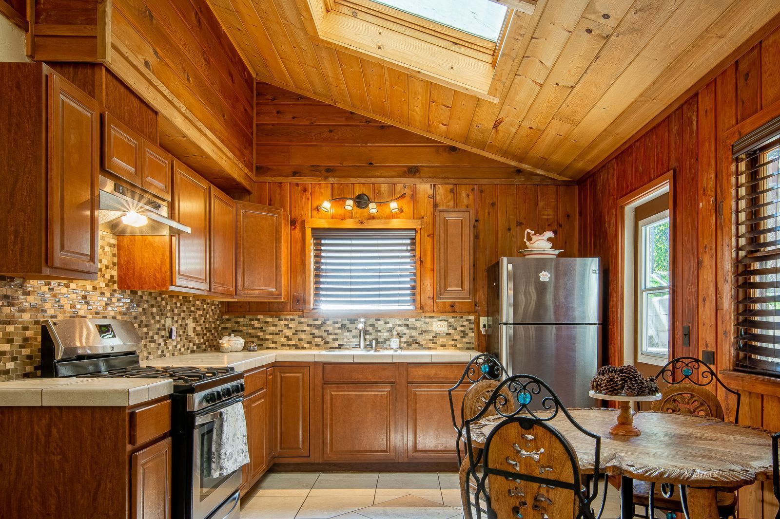 53545 Tollgate Road Idyllwild, CA 92549 - Photo 8 of 30 a utility room with stainless steel appliances a sink and cabinets