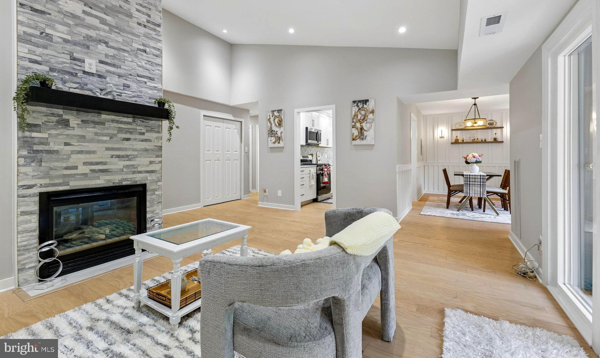 11841 Shire Court, Unit 31D Reston, VA 20191 - Photo 8 of 24 a living room with furniture a fireplace and a table