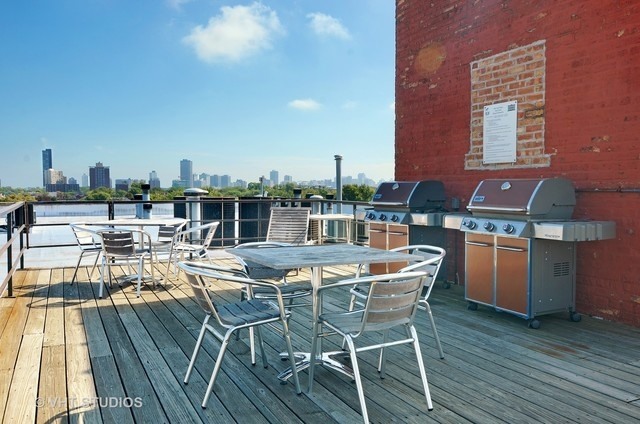1733 West Irving Park Road, Unit 403 Chicago, IL 60613 - Photo 11 of 11 a dinning table and chairs in a patio