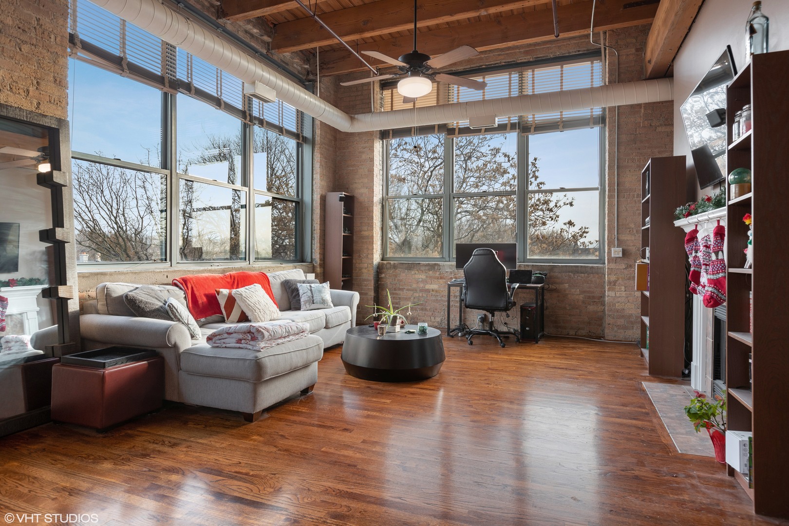 1733 West Irving Park Road, Unit 403 Chicago, IL 60613 - Photo 3 of 11 a living room with furniture floor to ceiling window and wooden floor