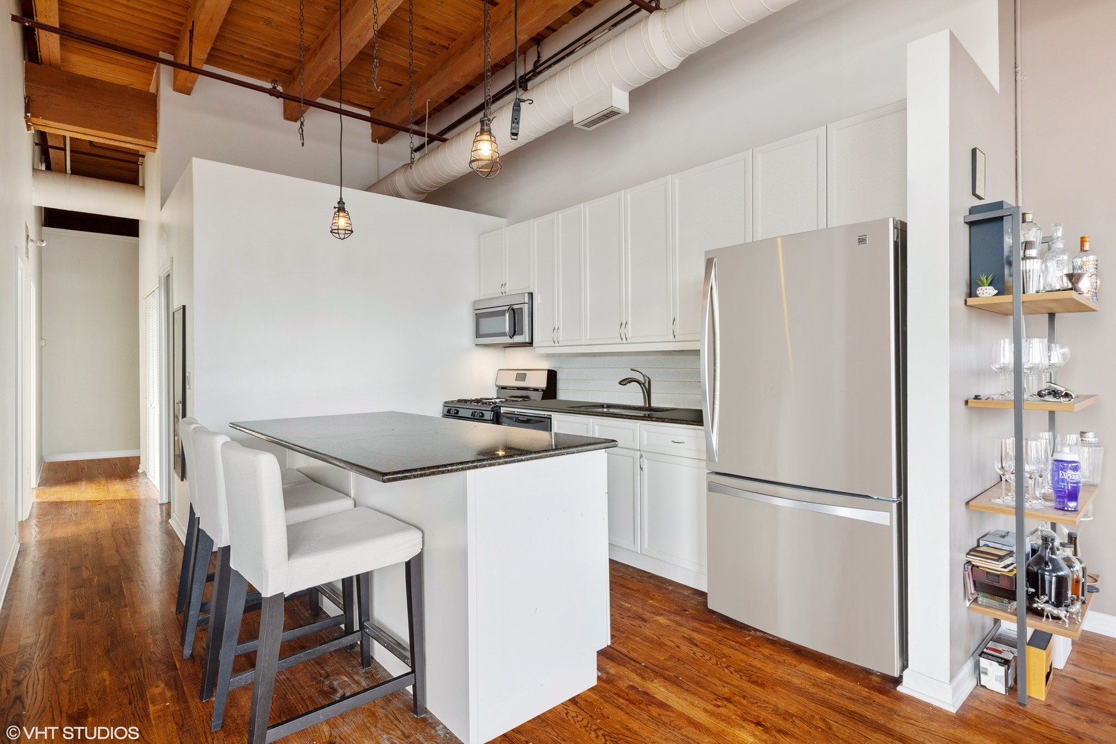 1733 West Irving Park Road, Unit 403 Chicago, IL 60613 - Photo 4 of 11 a kitchen with stainless steel appliances a refrigerator a stove a sink and a refrigerator