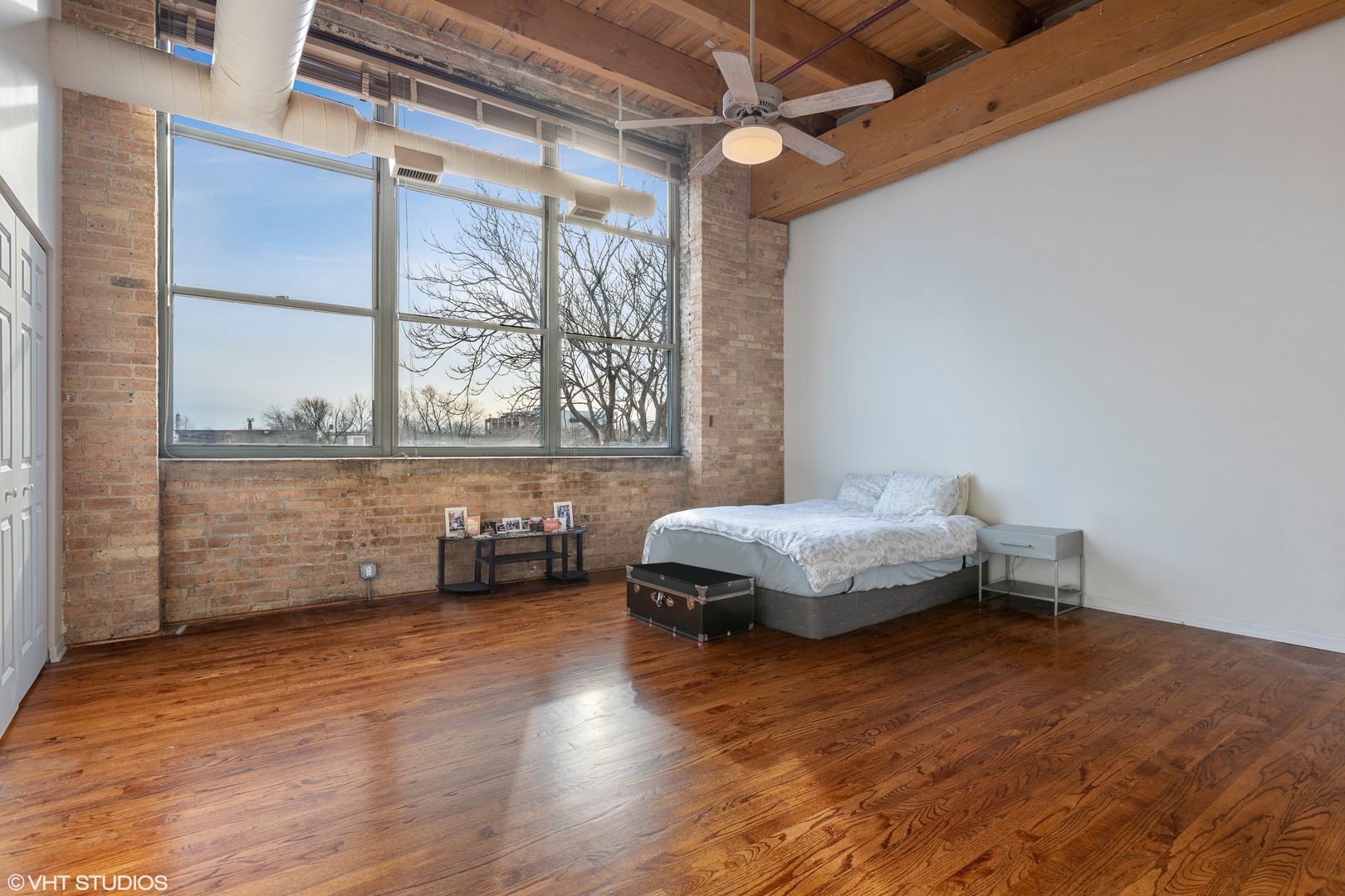 1733 West Irving Park Road, Unit 403 Chicago, IL 60613 - Photo 6 of 11 a bedroom with furniture and a window