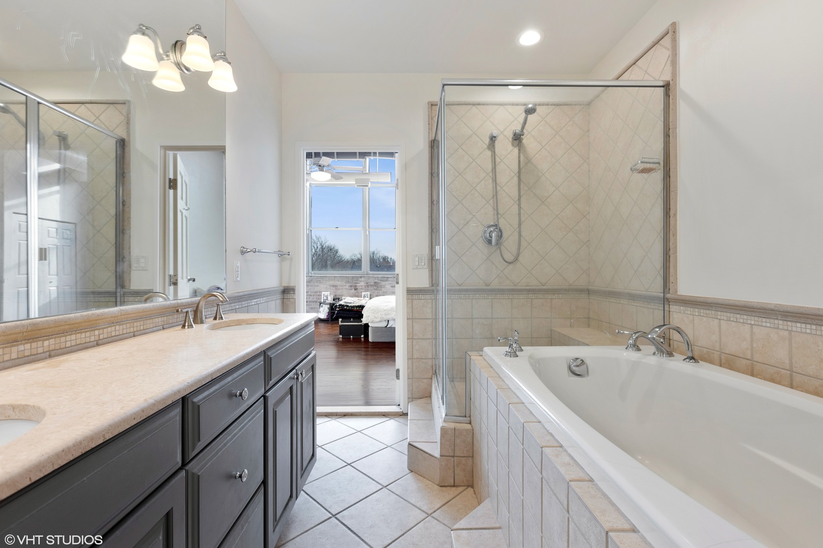 1733 West Irving Park Road, Unit 403 Chicago, IL 60613 - Photo 8 of 11 a bathroom with a tub sink and mirror