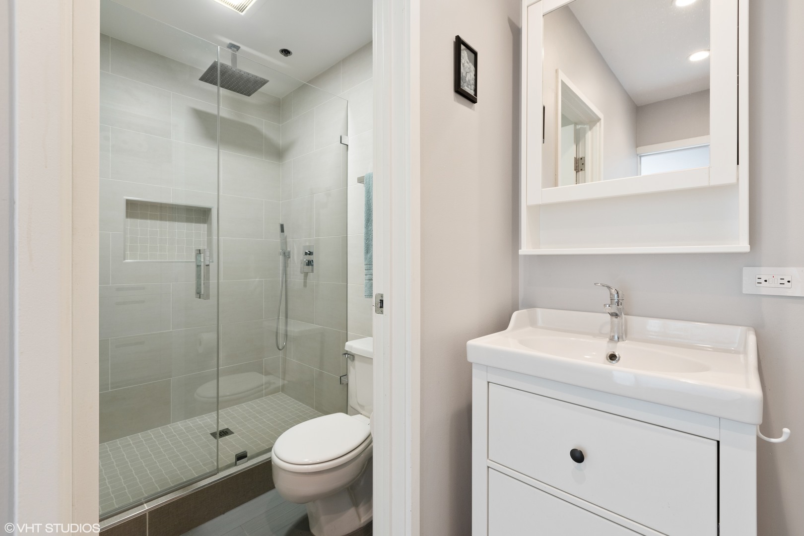 1733 West Irving Park Road, Unit 403 Chicago, IL 60613 - Photo 10 of 11 a bathroom with a sink a toilet and shower