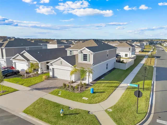 an aerial view of a house with a big yard