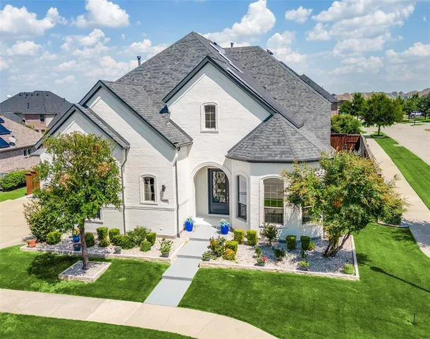 a front view of house with a garden and patio