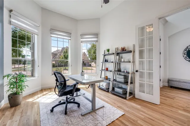 a workspace with wooden floor and a window