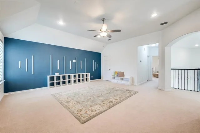 a bedroom with a bed a large mirror and a chandelier