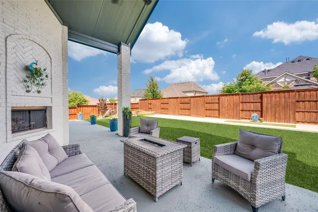 a outdoor living space with furniture and a fireplace