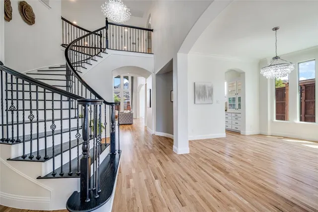 a view of entryway and hall with wooden floor