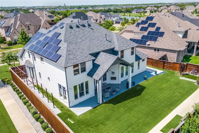 an aerial view of multiple houses with a big yard
