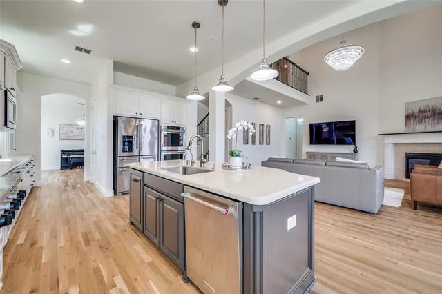 a large kitchen with stainless steel appliances kitchen island a large island in the center
