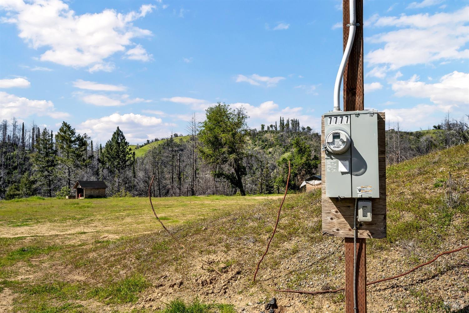 7777 Mill Creek Road Healdsburg, CA 95448 - Photo 18 of 18 a street sign on a wall next to a road