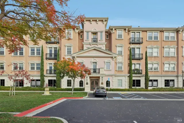 a front view of a residential apartment building with a yard