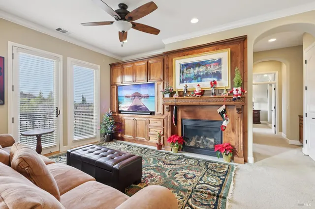 a living room with furniture a fireplace and a large window