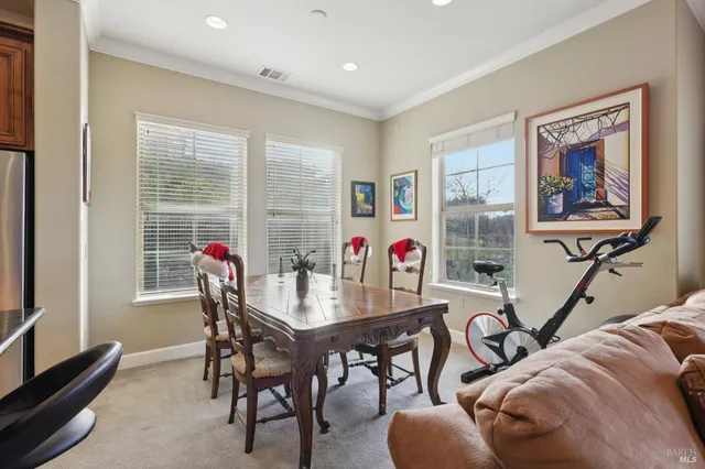 a view of a dining room with furniture and a potted plant