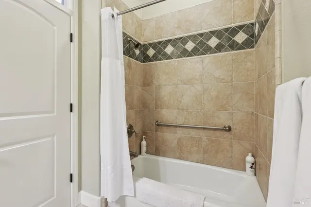 a bathroom with a bathtub and shower