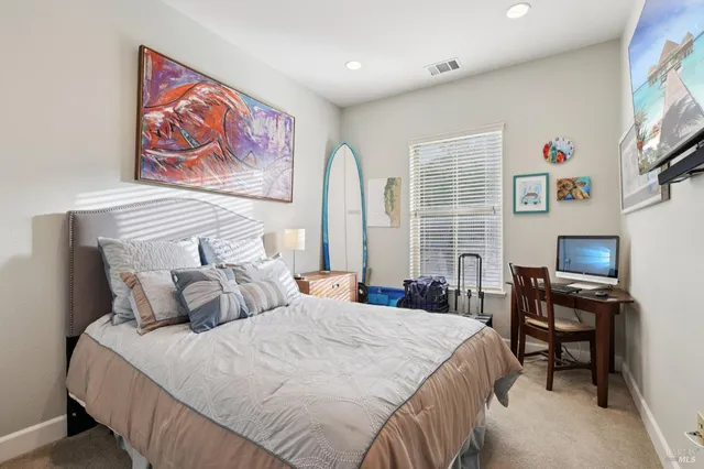 a bedroom with bed and a window