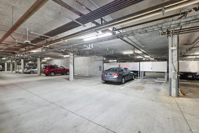 a view of parking garage with cars parked