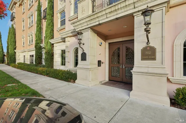 a view of a white house with a large windows